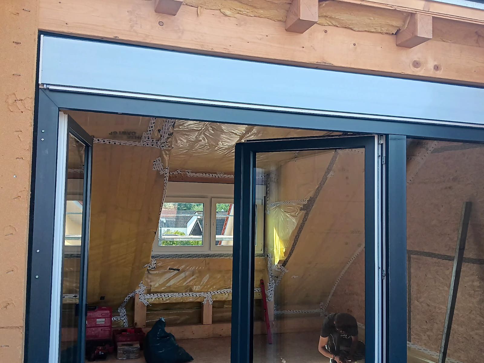 Anthrazitfarbene Doppel-Balkontür beim Einbau in der Loggia